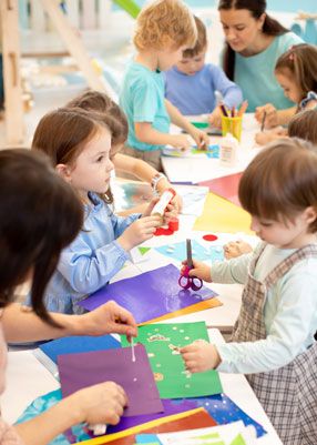 children making art around table